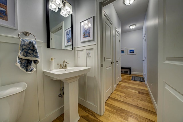 982 Lake Ridge Dr, Traverse City, MI 49684 - bathroom featuring wood finished floors and toilet