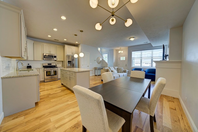 982 Lake Ridge Dr, Traverse City, MI 49684 - dining space featuring light wood-type flooring and recessed lighting