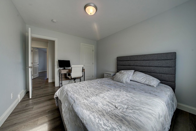 982 Lake Ridge Dr, Traverse City, MI 49684 - bedroom with baseboards and dark wood-style floors