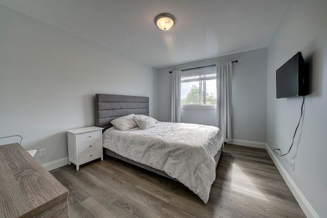 982 Lake Ridge Dr, Traverse City, MI 49684 - bedroom with dark wood-type flooring and baseboards