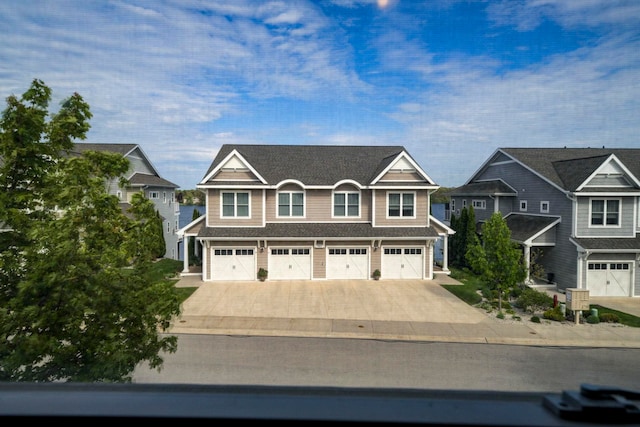 982 Lake Ridge Dr, Traverse City, MI 49684 - view of front facade featuring concrete driveway and a garage