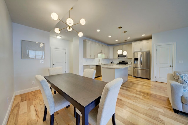 982 Lake Ridge Dr, Traverse City, MI 49684 - dining room with light wood-type flooring and recessed lighting