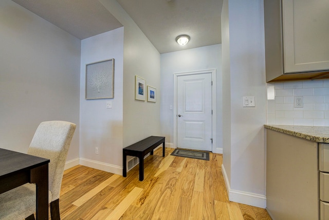 982 Lake Ridge Dr, Traverse City, MI 49684 - foyer entrance with light wood finished floors and baseboards