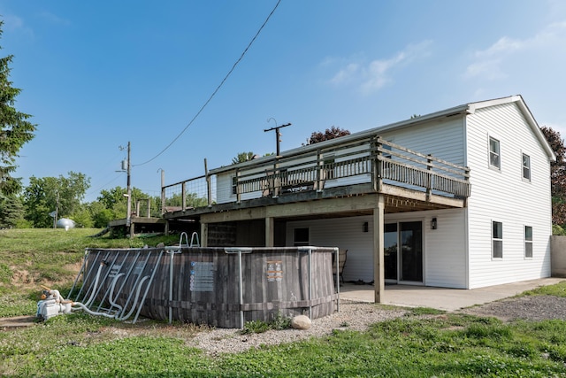 68026 Union Rd S, Union, MI 49130 - back of property featuring a wooden deck and a patio area