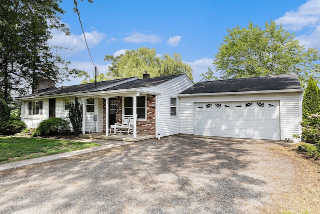 8565 Rives Junction Rd, Rives Junction, MI 49277 - ranch-style house with driveway, a porch, a chimney, brick siding, and a garage