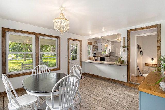 8565 Rives Junction Rd, Rives Junction, MI 49277 - dining room with a chandelier and light wood-type flooring