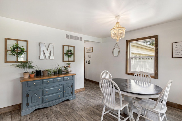 8565 Rives Junction Rd, Rives Junction, MI 49277 - dining area featuring a chandelier and dark wood-type flooring