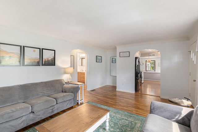 8565 Rives Junction Rd, Rives Junction, MI 49277 - living room with arched walkways and wood finished floors