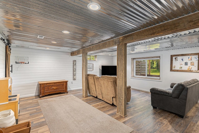 8565 Rives Junction Rd, Rives Junction, MI 49277 - living room featuring wood walls, wood finished floors, and plenty of natural light