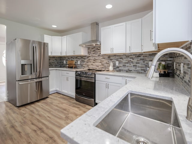 520 Della St, Portage, MI 49002 - kitchen featuring stainless steel appliances, wall chimney exhaust hood, white cabinets, light stone counters, and recessed lighting