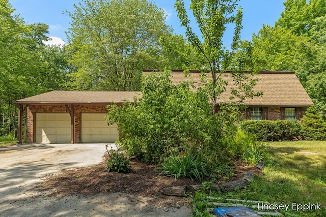 10201 Fillmore St, Zeeland, MI 49464 - view of front of house featuring brick siding, driveway, and a shingled roof