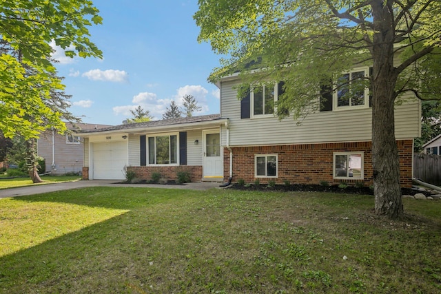 9241 Abbey Ln, Ypsilanti, MI 48198 - split level home with brick siding, asphalt driveway, an attached garage, and a front lawn