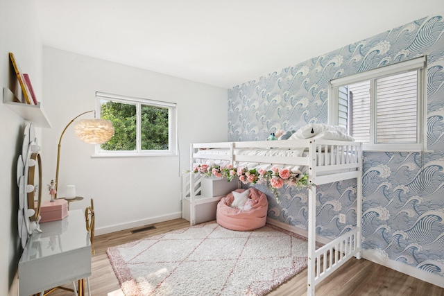 9241 Abbey Ln, Ypsilanti, MI 48198 - bedroom with multiple windows, wood finished floors, and wallpapered walls