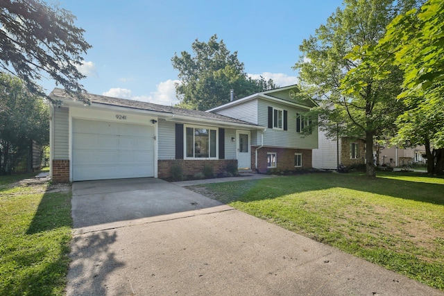 9241 Abbey Ln, Ypsilanti, MI 48198 - split level home with brick siding, an attached garage, driveway, and a front yard