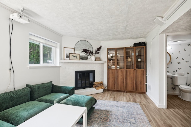 9241 Abbey Ln, Ypsilanti, MI 48198 - living area with a textured ceiling, wood finished floors, a brick fireplace, and ornamental molding
