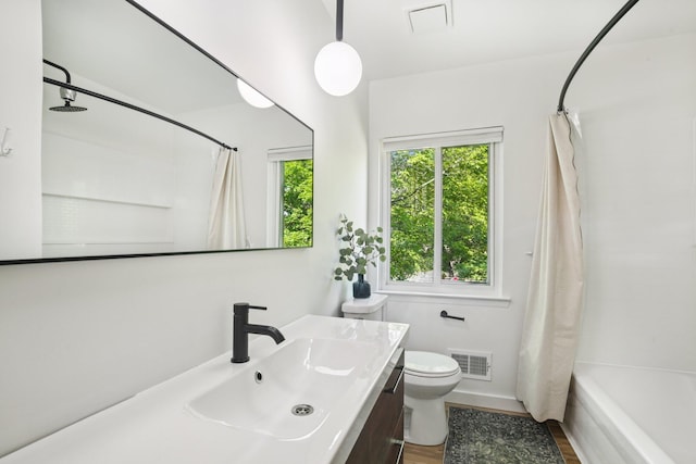 9241 Abbey Ln, Ypsilanti, MI 48198 - bathroom featuring healthy amount of natural light, vanity, shower / bath combo with shower curtain, and wood finished floors