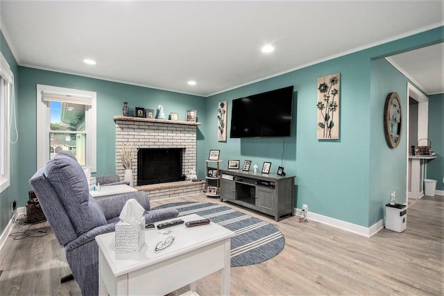 6779 1st Dr, Coloma, MI 49038 - living room with crown molding, light wood-style floors, recessed lighting, and a fireplace