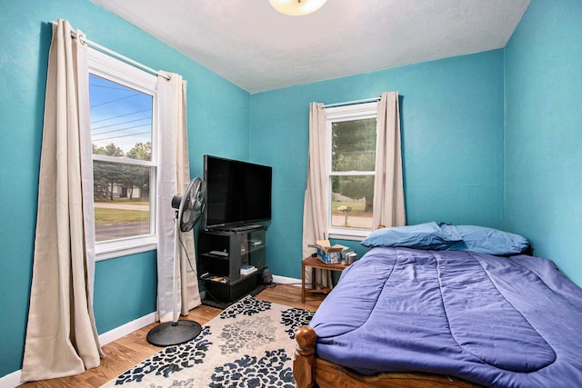 6779 1st Dr, Coloma, MI 49038 - bedroom featuring multiple windows and wood finished floors
