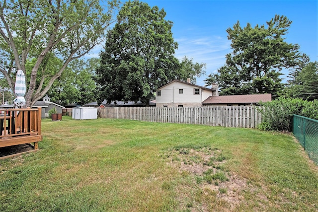 6779 1st Dr, Coloma, MI 49038 - fenced backyard with a shed and a wooden deck