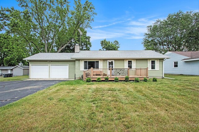 6779 1st Dr, Coloma, MI 49038 - ranch-style home featuring a garage, driveway, a chimney, a deck, and a front lawn