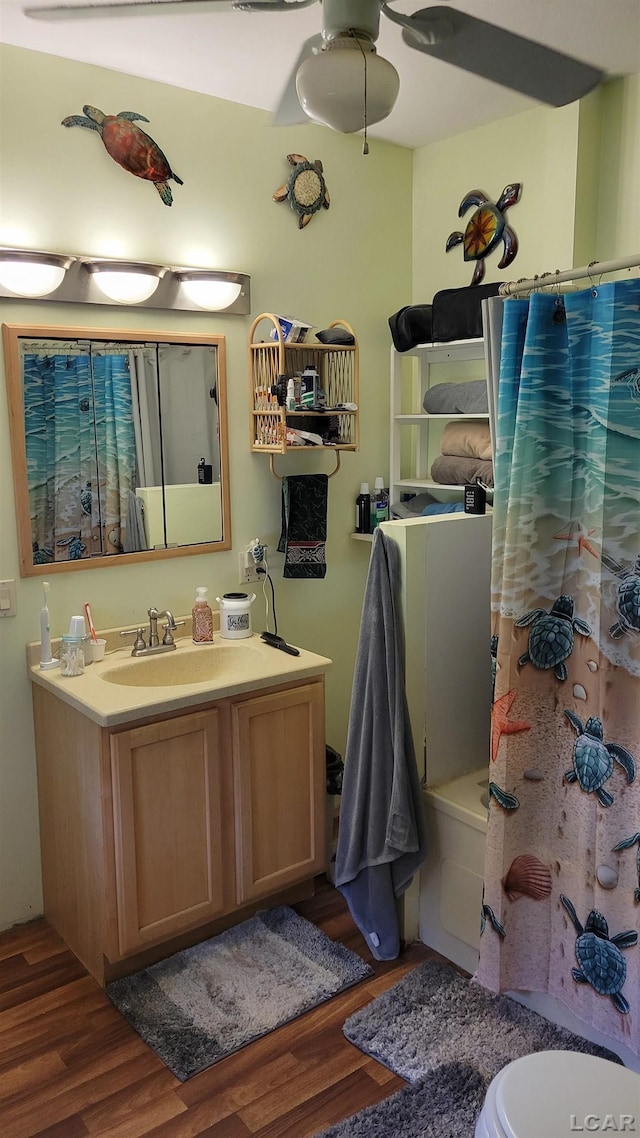 511 E Main St, Morenci, MI 49256 - bathroom featuring wood finished floors, vanity, a ceiling fan, and shower / bath combo with shower curtain
