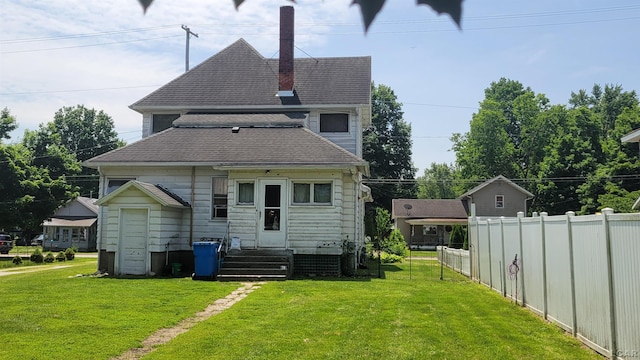 511 E Main St, Morenci, MI 49256 - back of property featuring roof with shingles, a chimney, and entry steps