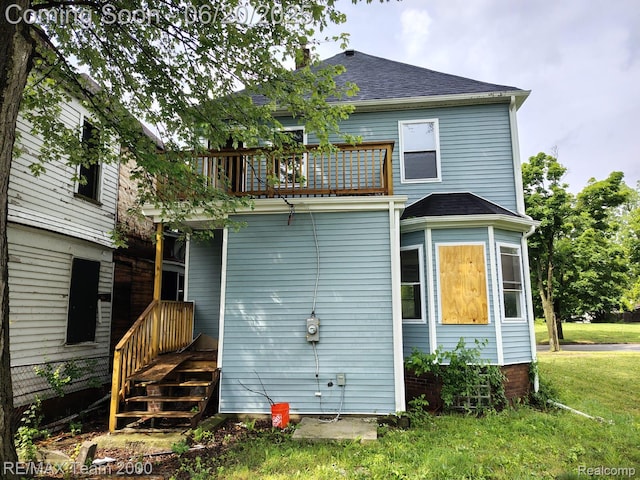 2492 Townsend St, Detroit, MI 48214 - rear view of property featuring a balcony, roof with shingles, and a lawn