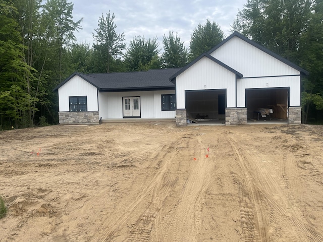 1513 Browning Dr, Grand Rapids, MI 49534 - modern inspired farmhouse with driveway, stone siding, an attached garage, and french doors
