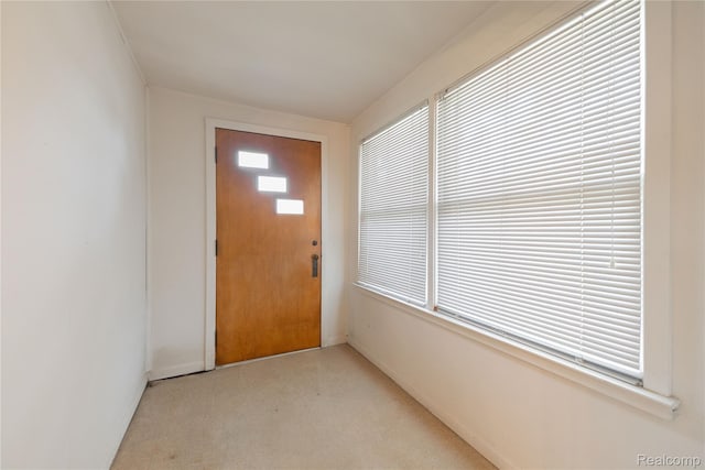 29463 Sibley Rd, Romulus, MI 48174 - doorway to outside with baseboards and light carpet