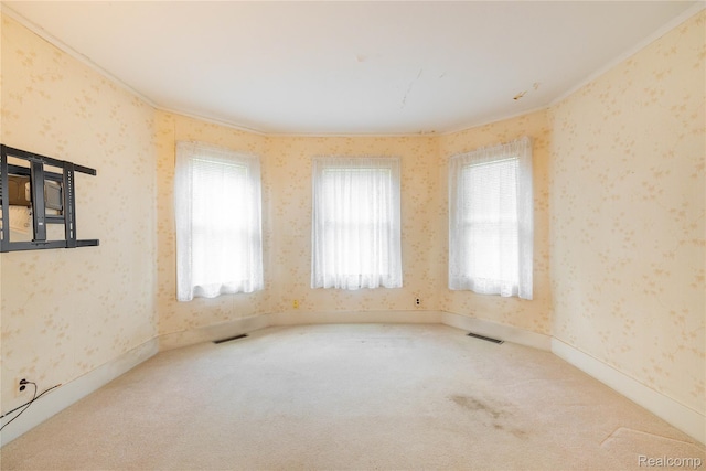 29463 Sibley Rd, Romulus, MI 48174 - spare room featuring wallpapered walls, carpet, ornamental molding, and healthy amount of natural light
