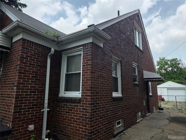19466 Packard St, Detroit, MI 48234 - view of property exterior featuring brick siding and a detached garage