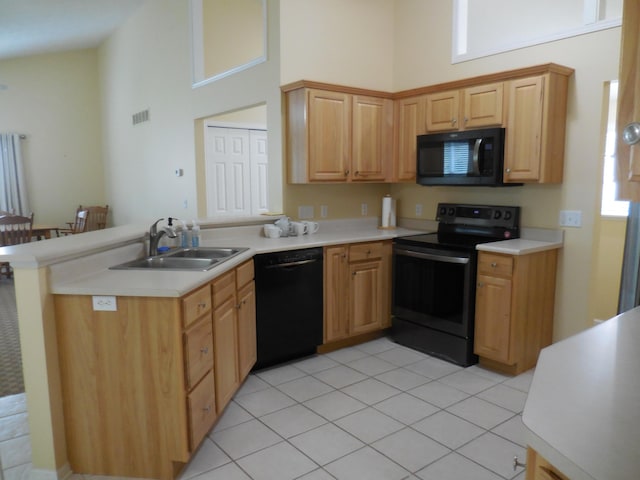8103 Robinbrook St, Richland, MI 49083 - kitchen with black appliances, a high ceiling, a peninsula, light countertops, and light tile patterned floors