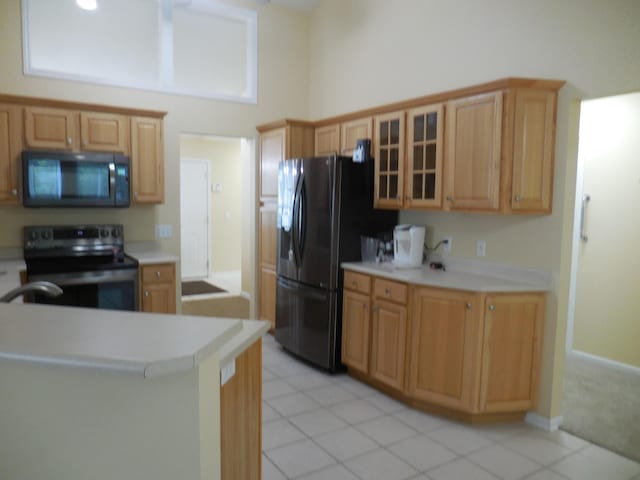 8103 Robinbrook St, Richland, MI 49083 - kitchen with stainless steel microwave, electric range oven, freestanding refrigerator, glass insert cabinets, and light countertops