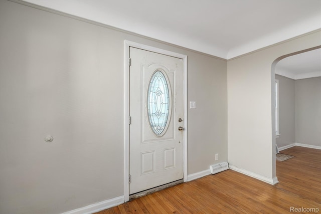 11487 Kenmoor St, Detroit, MI 48205 - foyer entrance featuring light wood finished floors, arched walkways, and ornamental molding