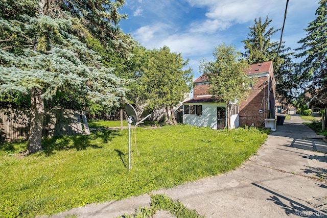 11487 Kenmoor St, Detroit, MI 48205 - view of home's exterior featuring brick siding and a lawn