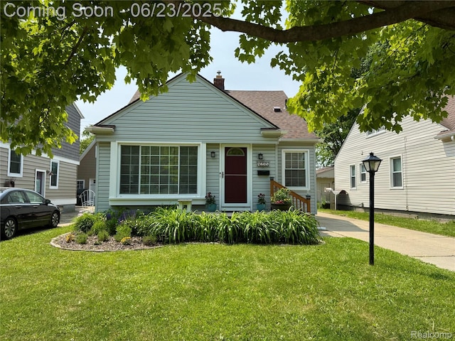 4235 Bacon Ave, Berkley, MI 48072 - bungalow-style house with a chimney, a front yard, and roof with shingles