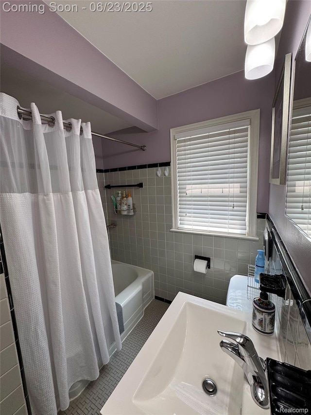 4235 Bacon Ave, Berkley, MI 48072 - bathroom featuring tile walls, healthy amount of natural light, shower / bath combo, tile patterned flooring, and a wainscoted wall
