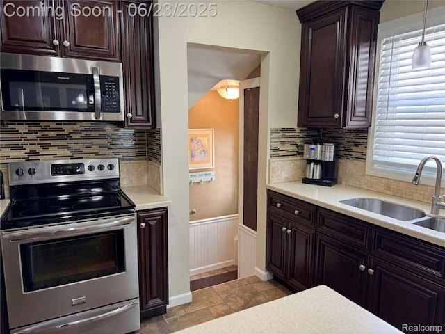 4235 Bacon Ave, Berkley, MI 48072 - kitchen with appliances with stainless steel finishes, light countertops, dark brown cabinets, backsplash, and wainscoting