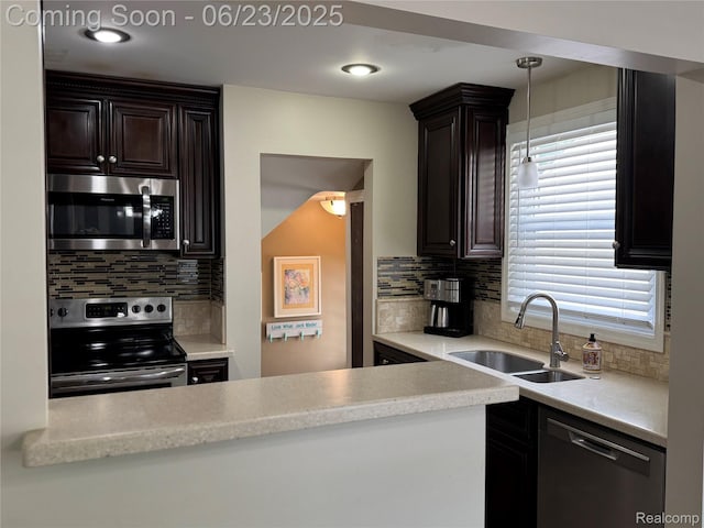 4235 Bacon Ave, Berkley, MI 48072 - kitchen with stainless steel appliances, tasteful backsplash, light countertops, and plenty of natural light