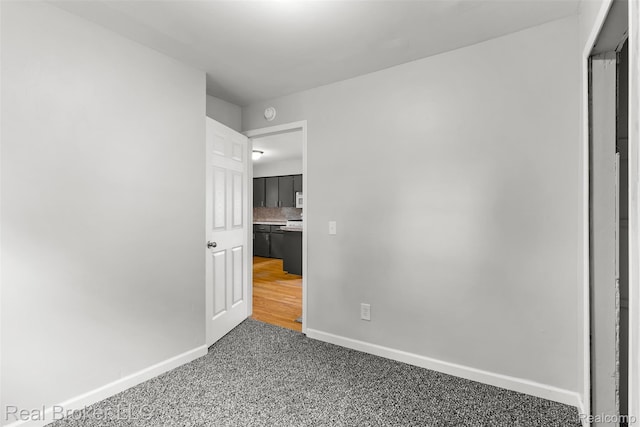 1059 Morris Hills Pkwy, Mount Morris, MI 48458 - unfurnished bedroom featuring baseboards and carpet