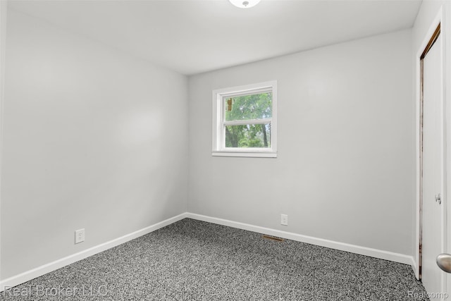 1059 Morris Hills Pkwy, Mount Morris, MI 48458 - unfurnished bedroom with baseboards and carpet flooring