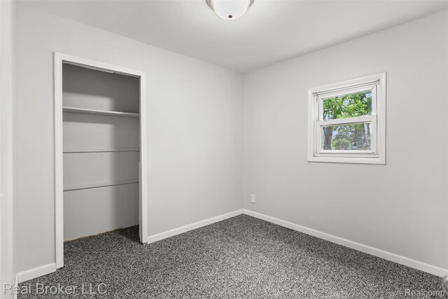 1059 Morris Hills Pkwy, Mount Morris, MI 48458 - unfurnished bedroom with dark colored carpet and a closet