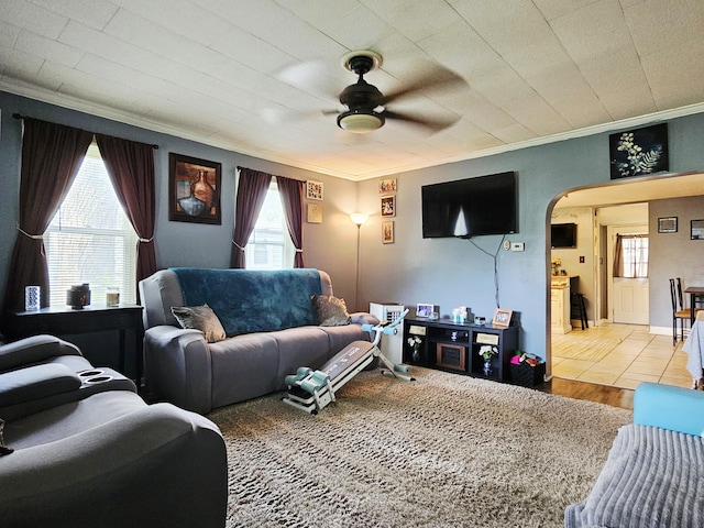 209 Sarah St, Adrian, MI 49221 - living area with crown molding, arched walkways, a ceiling fan, and wood finished floors