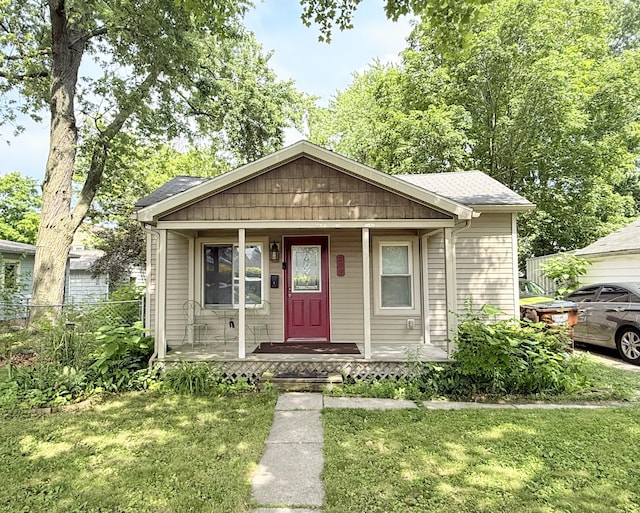 209 Sarah St, Adrian, MI 49221 - bungalow featuring a porch and roof with shingles