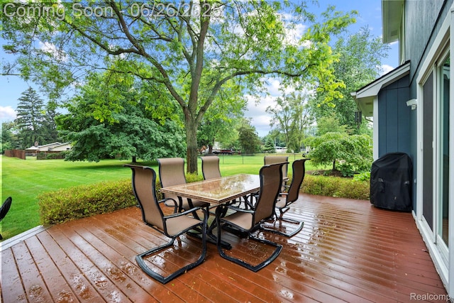 4386 Kelly Circle Dr, Commerce Twp, MI 48390 - deck featuring area for grilling, a lawn, outdoor dining area, and view of scattered trees
