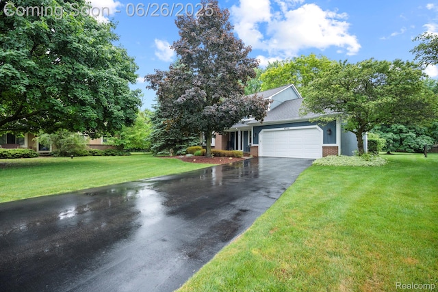 4386 Kelly Circle Dr, Commerce Twp, MI 48390 - obstructed view of property with driveway, brick siding, an attached garage, and a front yard
