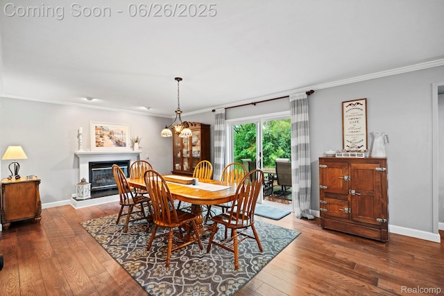 4386 Kelly Circle Dr, Commerce Twp, MI 48390 - dining room featuring ornamental molding, hardwood / wood-style flooring, and a glass covered fireplace