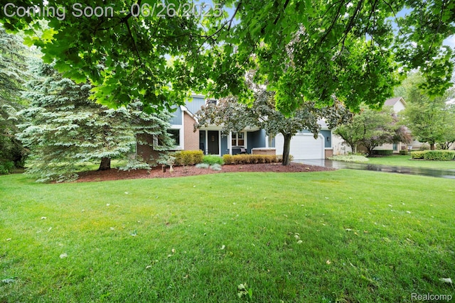 4386 Kelly Circle Dr, Commerce Twp, MI 48390 - view of property hidden behind natural elements with a garage, a front lawn, and brick siding