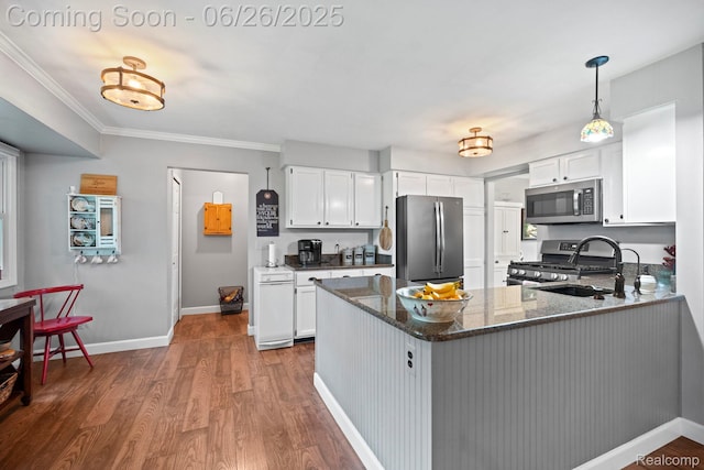 4386 Kelly Circle Dr, Commerce Twp, MI 48390 - kitchen with stainless steel appliances, dark stone countertops, a peninsula, wood finished floors, and white cabinets