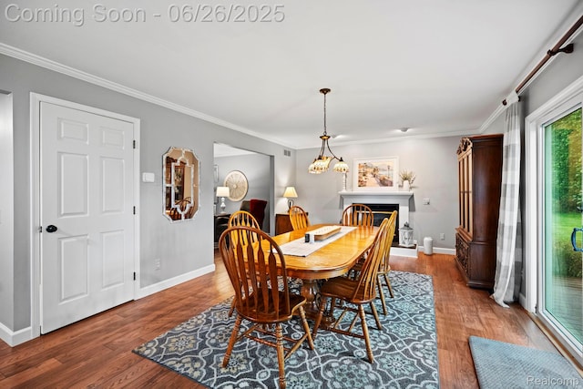 4386 Kelly Circle Dr, Commerce Twp, MI 48390 - dining area with crown molding, wood finished floors, and a fireplace with raised hearth